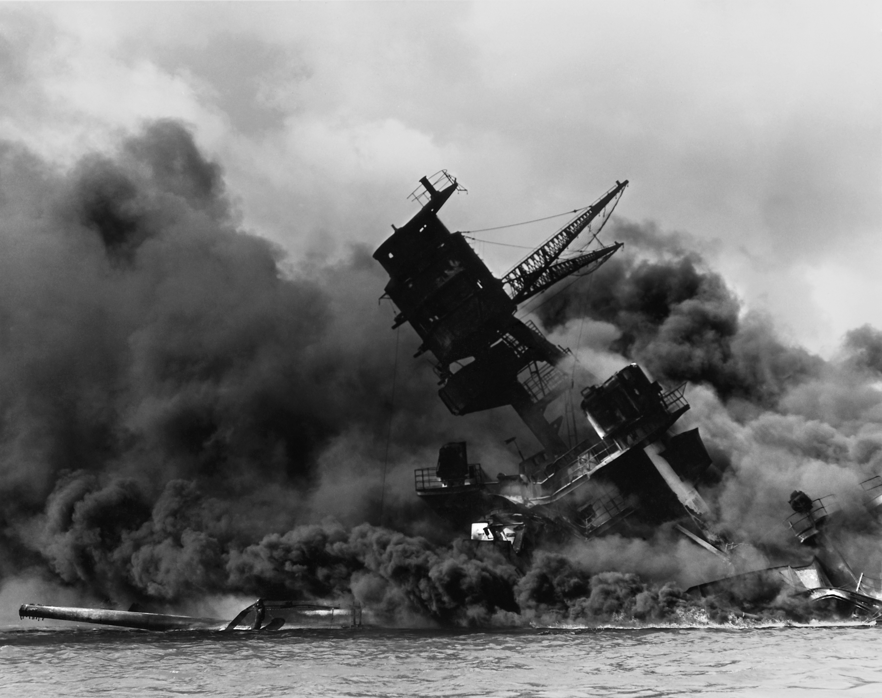 A ship, the USS Arizona, burning after the Japanese attack on Pearl Harbor